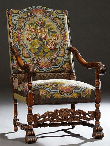 French Carved Walnut Fauteuil a la Reine, late 19th c., the arched canted back issuing two scrolled arms, to a cushion seat, on turn...