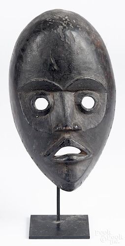 African carved mask by the Dan tribe of the Ivory Coast and Liberia, 10'' h.