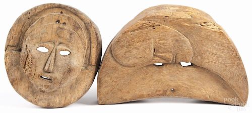 Two African carved wood masks, 9 1/2'' h., 8'' w. and 8'' h., 13'' w.