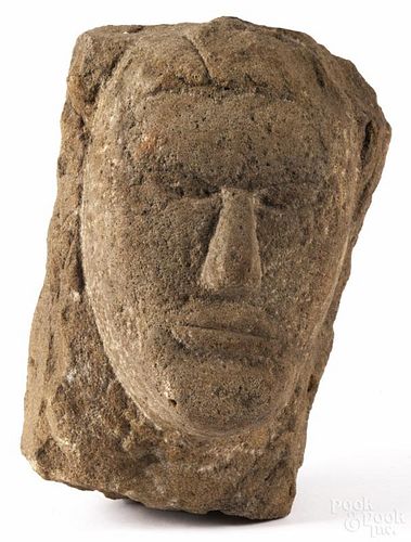 Primitive carved stone face, 10'' h., 7'' w. Provenance: DeHoogh Gallery, Philadelphia.
