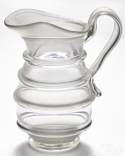Blown molded colorless glass water pitcher, 19th c., with an applied handle, 9 1/4'' h.