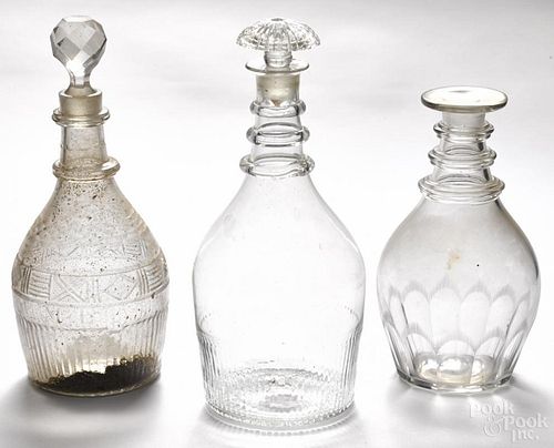 Three blown molded colorless glass decanters, 19th c., with applied rings and cut accents