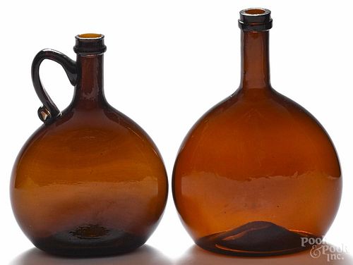 Two American blown molded amber glass flasks, 19th c., one with an applied handle, 7 1/2'' h.