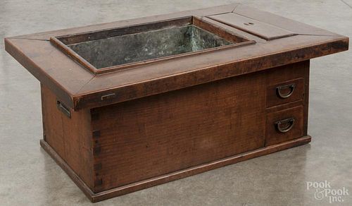 Japanese keyaki wood hibachi, 19th c., with a fitted copper liner and two drawers, 11 1/2'' h., 29'' w.