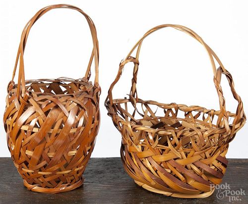 Two Japanese ikebana bamboo baskets, 20th c., 14'' h. and 15'' h.