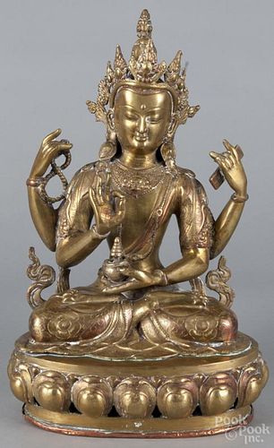 Tibetan gilt and copper painted bronze figure of Quan Yin with a copper base, 17'' h.