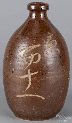 Japanese Tamba-ware sake jug, late Edo period, decorated with unglazed Kanji script, 12 1/4'' h.