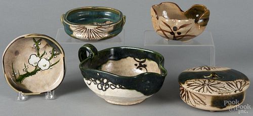 Five pieces of Japanese Oribe-ware, to include a covered dish, three open dishes, and a pitcher.