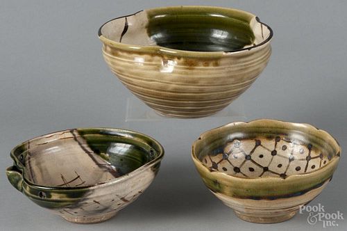 Three Japanese Oribe-ware bowls, to include two spouted examples and one with an interior brown glaze