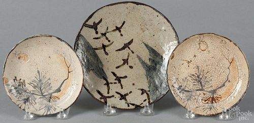 Pair of Japanese Shino-ware saucers, together with a small plate, 6 1/4'' dia.