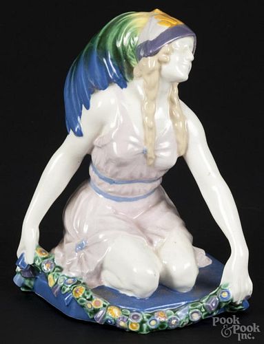 Continental porcelain figure of a kneeling woman, 20th c., wearing a multi-colored feather hat