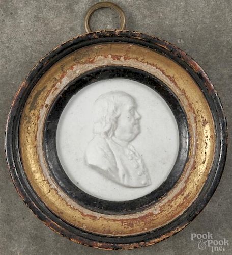 French biscuit porcelain portrait roundel, featuring a relief profile of Benjamin Franklin, 18th c.
