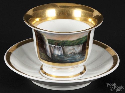 American gilt and painted porcelain tea cup and saucer, early/mid 19th c., with a hand-painted view