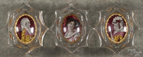 Three Continental clear glass ashtrays, early 19th c., with hand-painted resin plaques