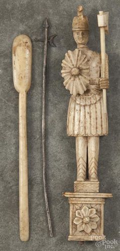 Two bone articles, 19th c., to include a snuff spoon and a decorative soldier on a pedestal