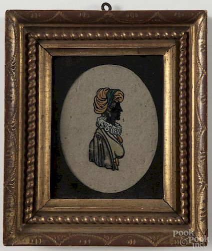Reverse painted miniature silhouette of a lady, 19th c, with gold leaf paint in a carved frame