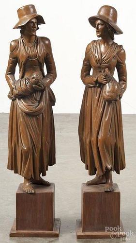 Pair of carved women on pedestal bases, 20th c., unsigned, 21 3/4'' h. Provenance: DeHoogh Gallery