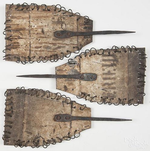 Three wrought iron and sheet metal noise makers, 15'' l. Provenance: DeHoogh Gallery, Philadelphia.
