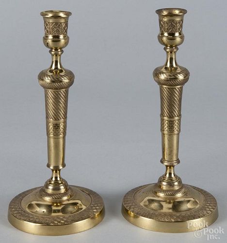 Pair of French style brass candlesticks with detailed beaded and overlapping scale accents, unmarked