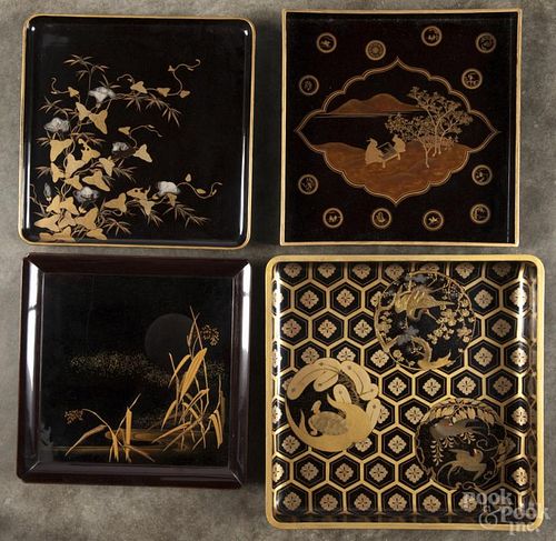 Five Japanese lacquerware trays with gold and silver detailing, largest - 12 1/2'' l., 12 1/2'' w.