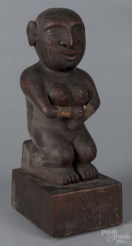 Carved African figure, 19th c., with sewn leather arm bands, 14'' h. Provenance: DeHoogh Gallery