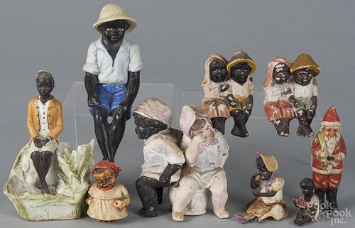 Black Americana figures, mid 20th c., together with a Japanese bisque Santa figure, 3 3/4'' h.