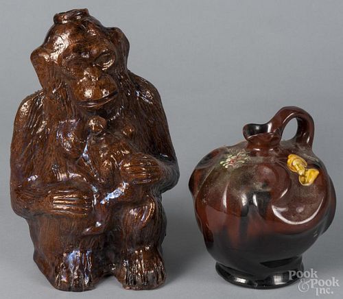 Continental redware monkey bottle, 19th c., 12'' h., together with a redware pitcher with a portrait
