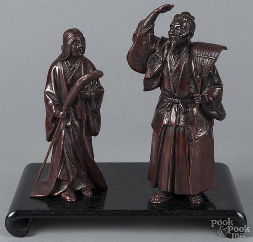 Pair of Japanese patinated bronze figures of a man and a woman with a rake and a broom, 9 3/4'' h.