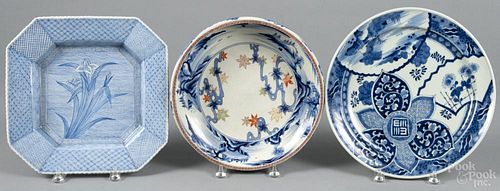 Three export porcelain shallow bowls, to include a Chinese bowl bearing a Chien Lung mark on its base