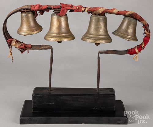 Set of early brass bells on stand
