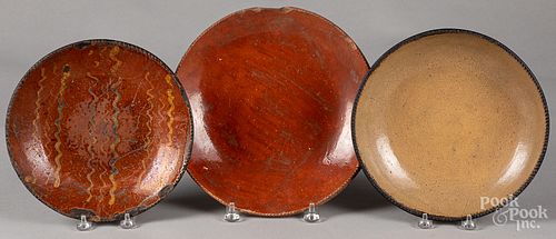 Three redware plates, 19th c.