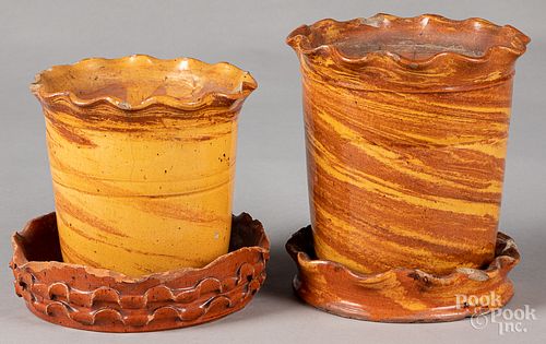 Two redware flowerpots, 19th c., with undertrays