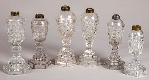 Six colorless glass fluid lamps.