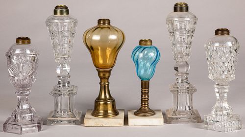 Six glass fluid lamps.