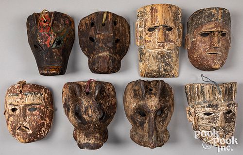 Eight carved and painted Mexican masks