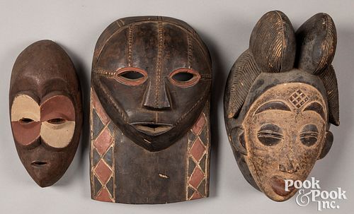 Three African carved and painted masks