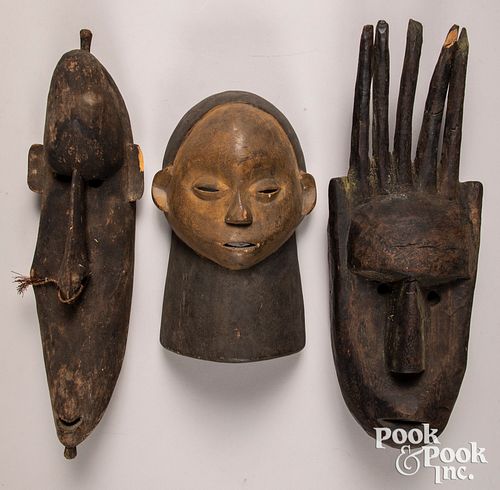 Three carved African masks