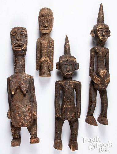 Four carved wooden tribal statues