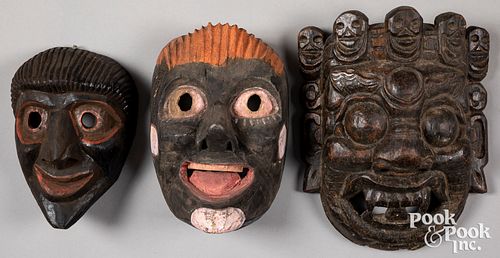 Three Nepalese carved and painted masks