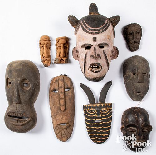Seven carved tribal masks