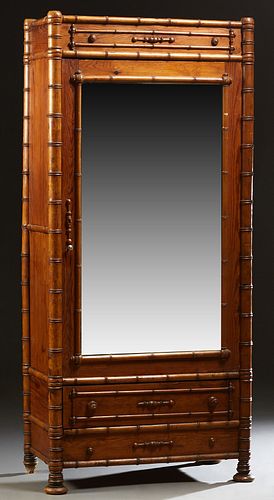English Pitch Pine Faux Bamboo Armoire, c. 1880, the applied carving top over a single mirror door, opening to an interior with two shelves, on a base
