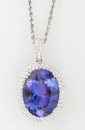 Platinum Pendant with an oval 25.21 ct. tanzanite atop a double graduated concentric border of round diamonds, with a diamond mounted bail, on an 18K 