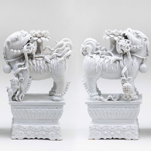 Pair of Chinese White Glazed Porcelain Buddhistic Lion Candle Holders