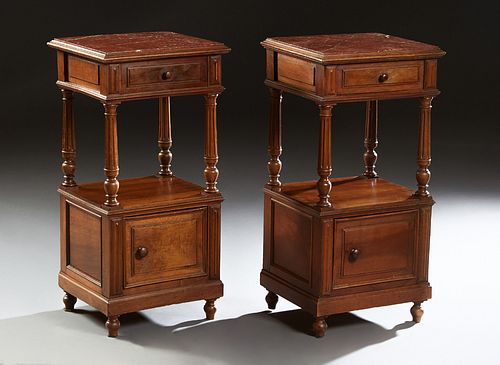 Pair of French Carved Walnut Marble Top Nightstands, c. 1870, the inset highly figured rouge marble over a frieze drawer, on turned reeded supports to