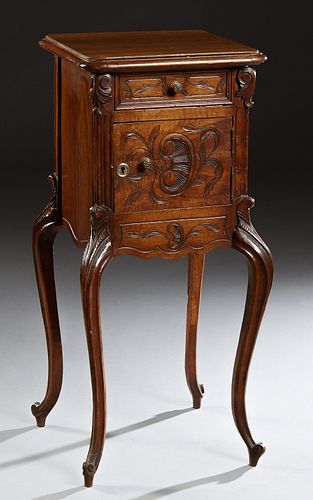 French Louis XV Style Carved Walnut Nightstand, early 20th c., the stepped rounded edge and corner top over a frieze drawer and a pot cupboard, on ree