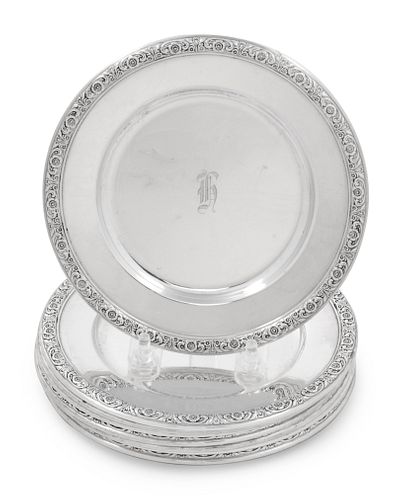 A Set of Eight International Sterling Bread Plates