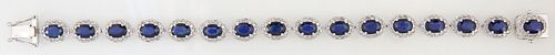 14K White Gold Link Bracelet, each of the 16 oval links with a dark blue oval sapphire atop a border of tiny round diamonds, total sapphire wt.- 13.04