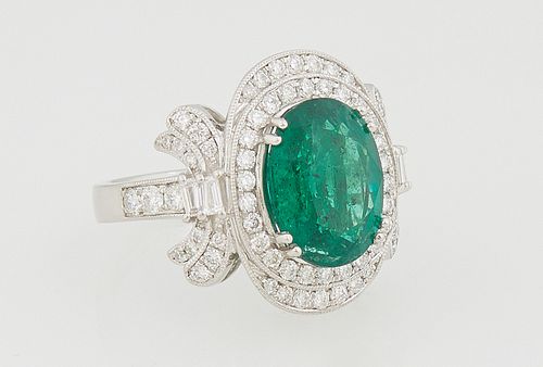 Lady's Platinum Dinner Ring, with an oval 4.45 ct. emerald, atop a border of round white diamond and like lower edge borders on two sides, to round an