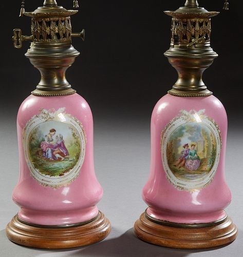 Pair of French Brass and Porcelain Carcel Style Lamps, 20th c., the baluster sides with reserves of courting couples, on a stepped circular wood base,