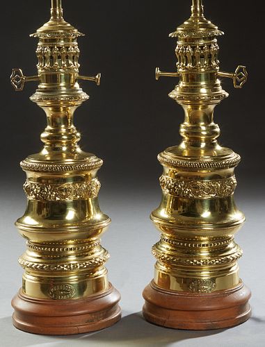 Pair of French Brass Repousse Oil Style Lamps, 20th c., the pierced necks on stepped relief decorated knopped support, to a stepped circular modern ba